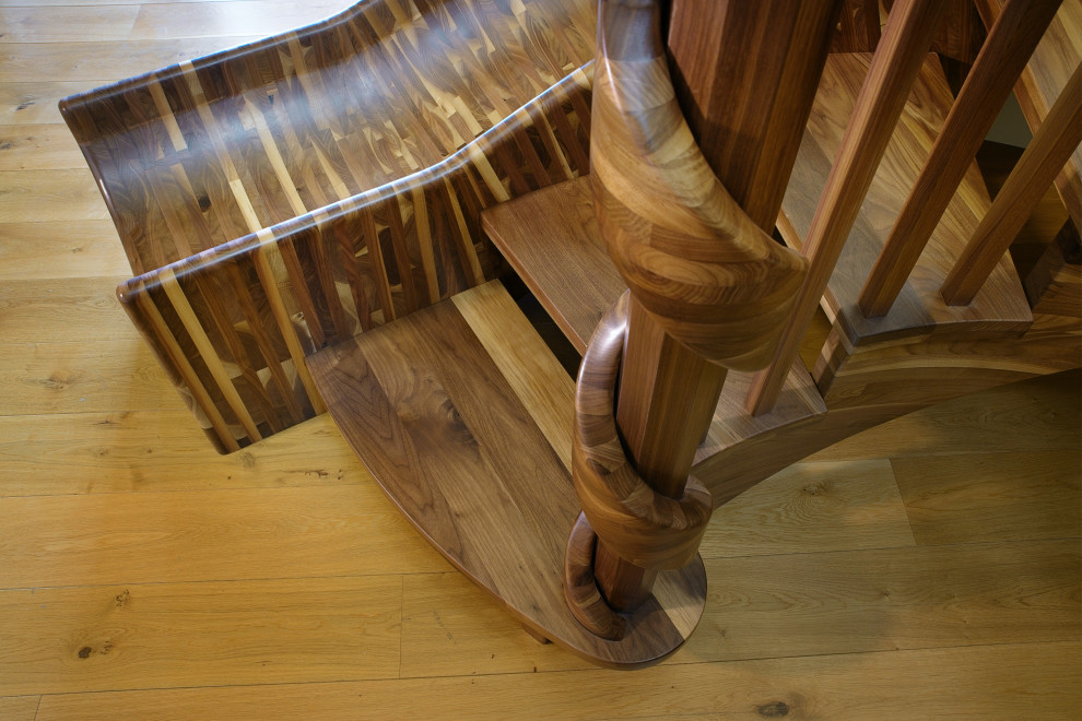 Photo of an expansive eclectic wood curved staircase in Sacramento with open risers and wood railing.