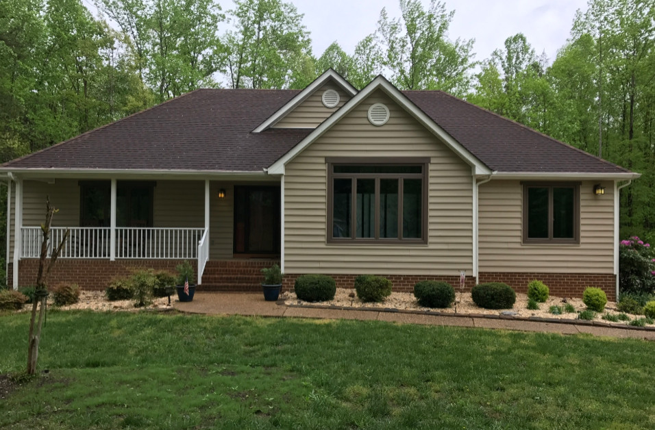 Inspiration for a mid-sized timeless beige two-story vinyl house exterior remodel with a shingle roof and a hip roof