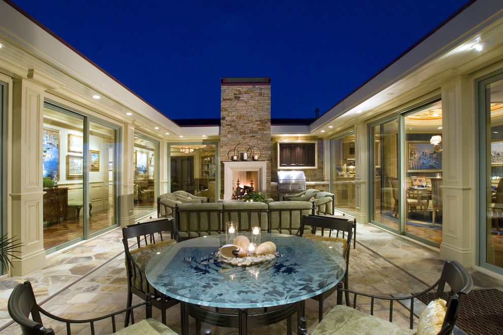 Photo of a traditional courtyard patio in Los Angeles with a fire feature.