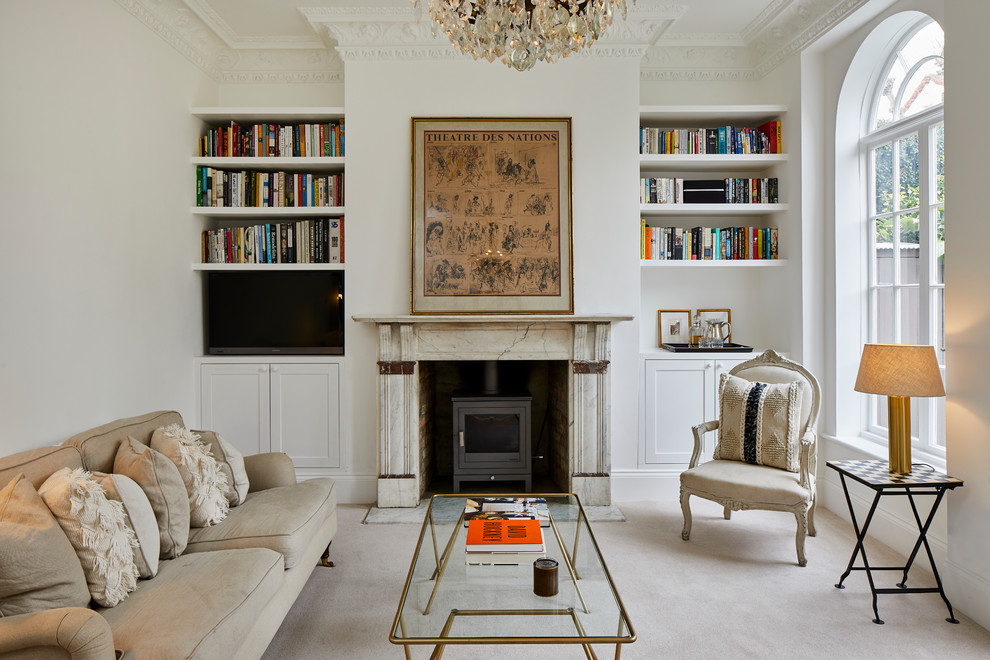 Inspiration for a traditional enclosed living room in London with white walls, carpet, a wood stove and white floor.