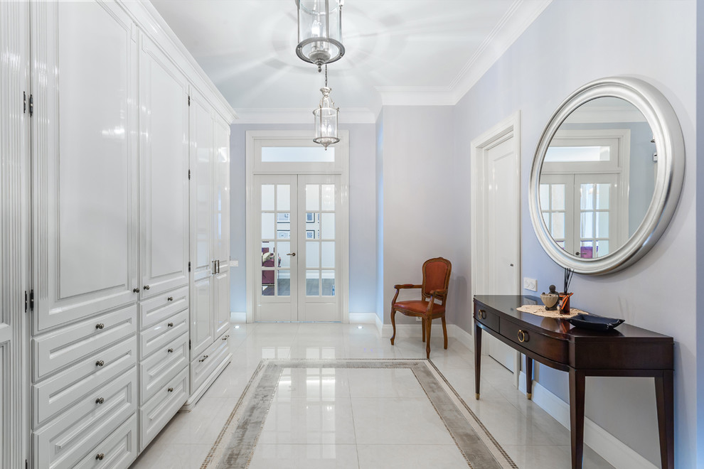 Large transitional foyer in Moscow with blue walls, porcelain floors and white floor.