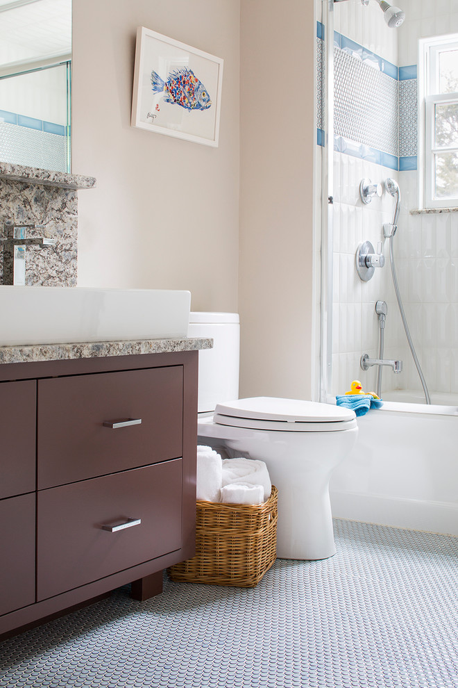 Photo of a transitional bathroom in Boston with a trough sink, furniture-like cabinets, brown cabinets, granite benchtops, an alcove tub, a shower/bathtub combo, a two-piece toilet, white tile, porcelain tile, beige walls and mosaic tile floors.
