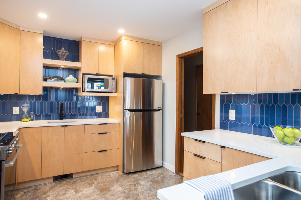 Mid-sized modern l-shaped separate kitchen in Other with an undermount sink, flat-panel cabinets, light wood cabinets, quartz benchtops, blue splashback, ceramic splashback, stainless steel appliances, vinyl floors, no island, beige floor and white benchtop.