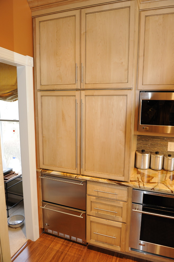 Eat-in kitchen - mid-sized transitional u-shaped light wood floor eat-in kitchen idea in Baltimore with a farmhouse sink, beaded inset cabinets, light wood cabinets, onyx countertops, stainless steel appliances and an island