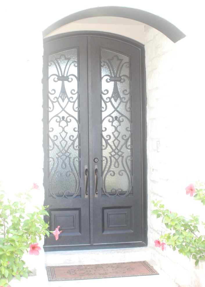 Small mediterranean front door in Houston with a double front door and a black front door.