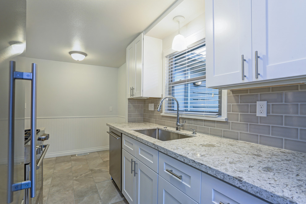 Inspiration for a transitional kitchen remodel with shaker cabinets, white cabinets, granite countertops, beige backsplash, cement tile backsplash, no island and multicolored countertops