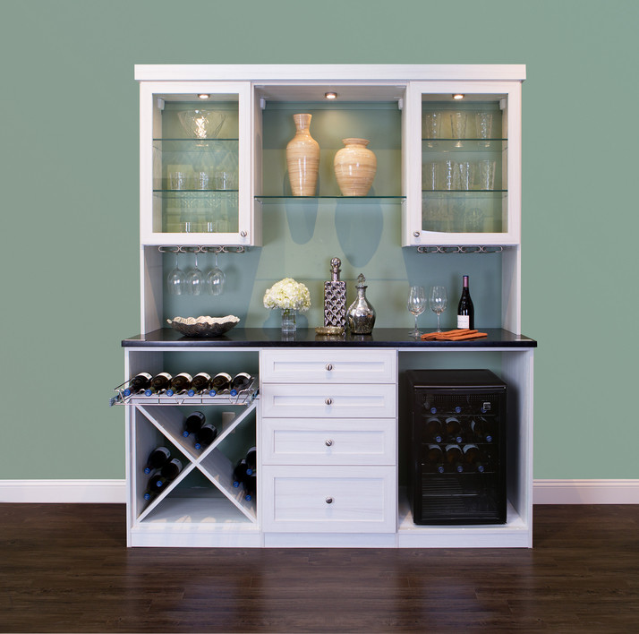 Inspiration for a small transitional single-wall wet bar in San Francisco with no sink, glass-front cabinets, white cabinets, laminate benchtops, green splashback, dark hardwood floors and brown floor.