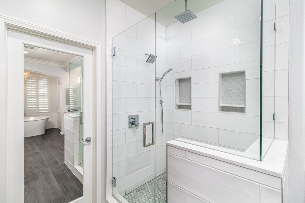 Large traditional master bathroom in Los Angeles with shaker cabinets, white cabinets, a freestanding tub, gray tile, glass tile, white walls, porcelain floors, an undermount sink, engineered quartz benchtops, grey floor and white benchtops.