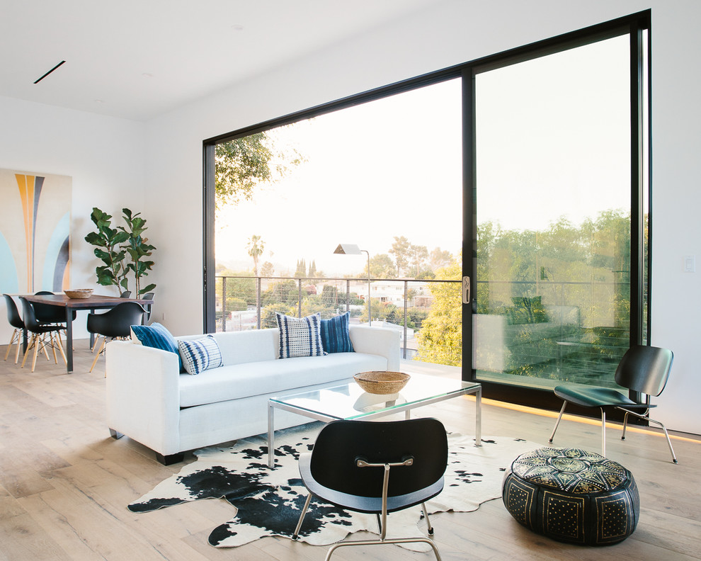Living room - contemporary open concept light wood floor living room idea in Los Angeles with white walls