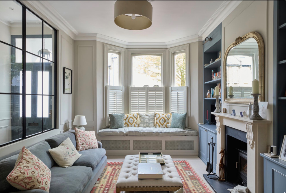 This is an example of a large classic formal enclosed living room in Surrey with beige walls, carpet and a ribbon fireplace.