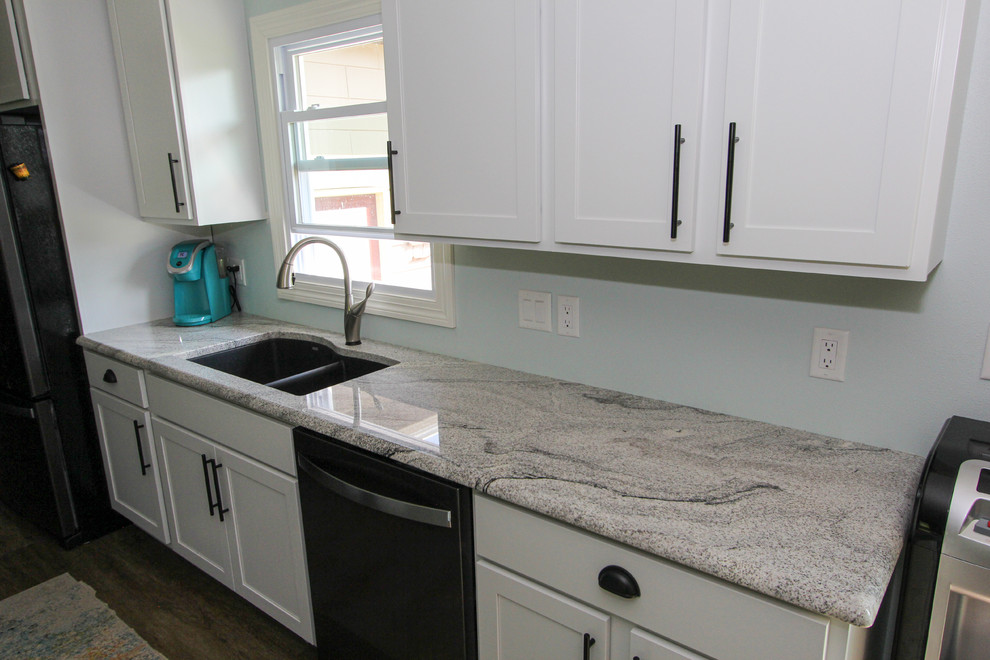 Mid-sized transitional single-wall laminate floor and brown floor open concept kitchen photo in Minneapolis with an undermount sink, shaker cabinets, gray cabinets, granite countertops, stainless steel appliances, an island and gray countertops