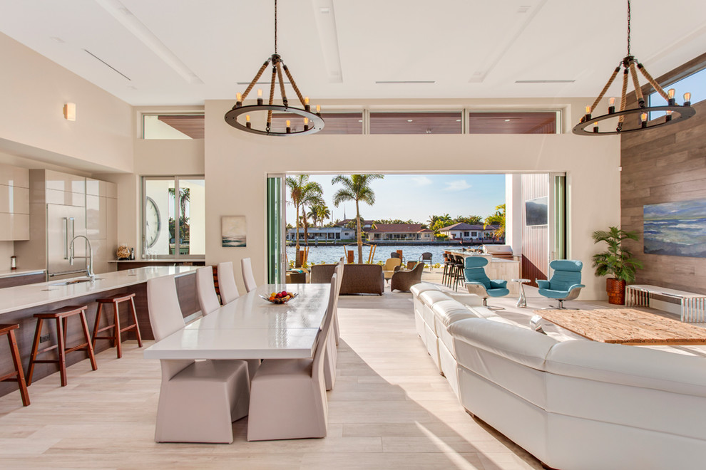 Large trendy formal and enclosed light wood floor and beige floor living room photo in Miami with beige walls, a ribbon fireplace, a plaster fireplace and a wall-mounted tv