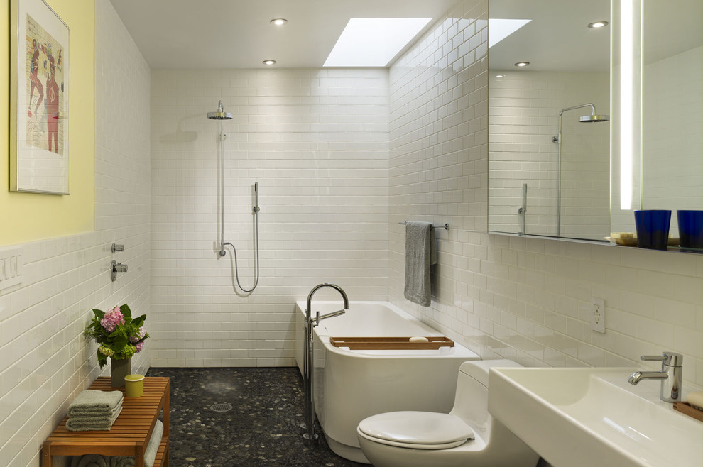 This is an example of a modern bathroom in Philadelphia with subway tile and pebble tile floors.