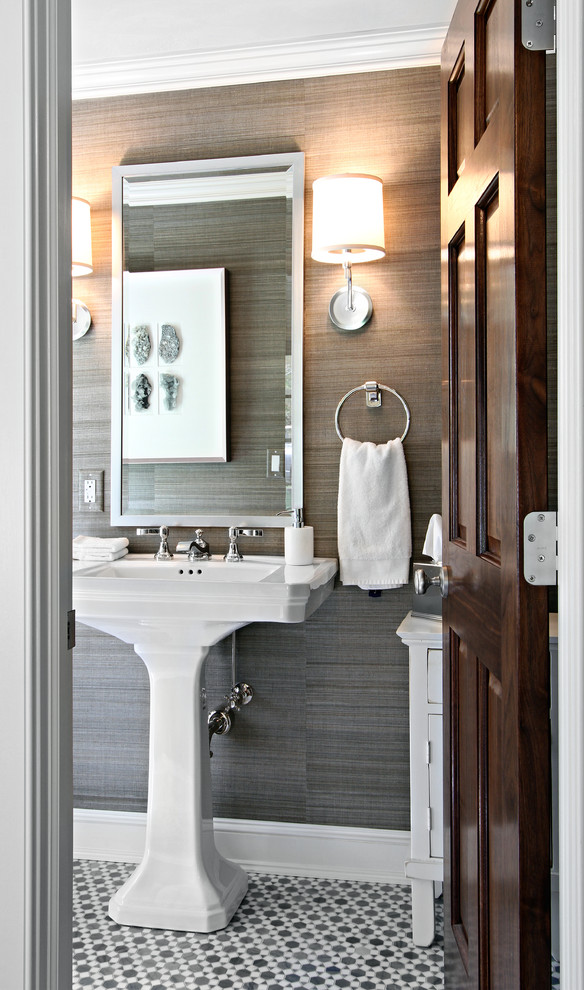 Inspiration for a small transitional powder room in New York with a pedestal sink, mosaic tile floors and grey walls.