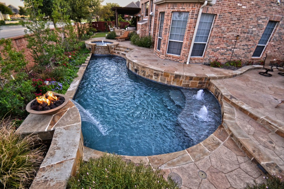 Small contemporary backyard custom-shaped pool in Dallas with a water feature and stamped concrete.