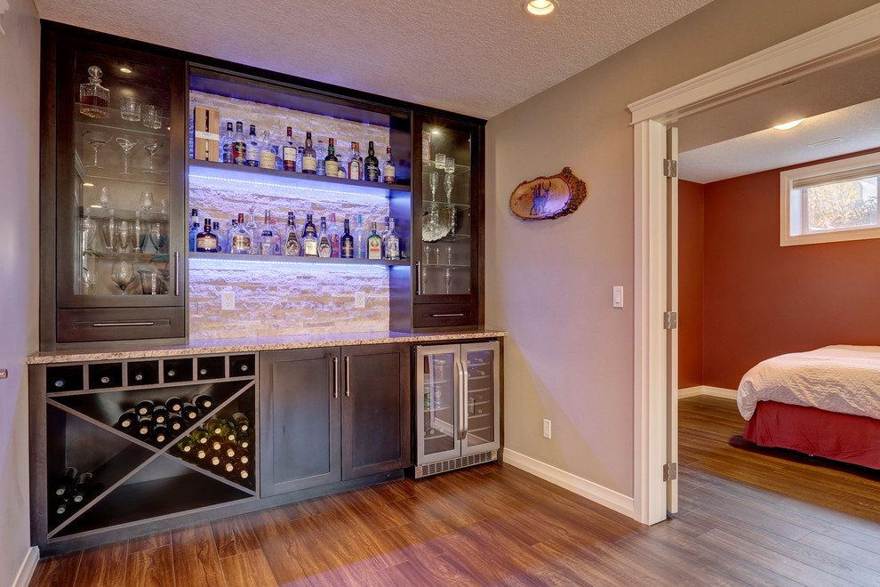 Example of a transitional home design design in Calgary