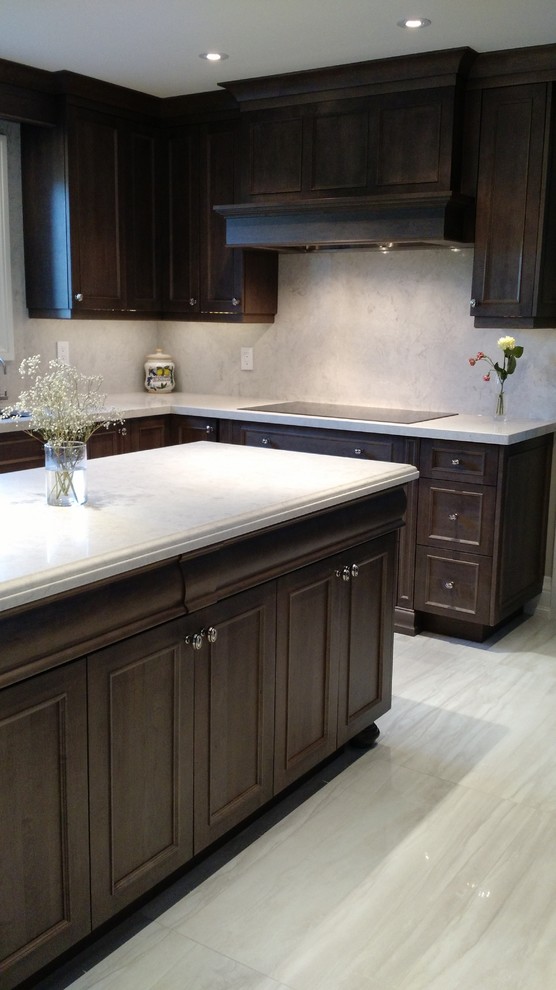 Eat-in kitchen - large transitional u-shaped porcelain tile eat-in kitchen idea with an undermount sink, medium tone wood cabinets, solid surface countertops, stone slab backsplash, stainless steel appliances and an island