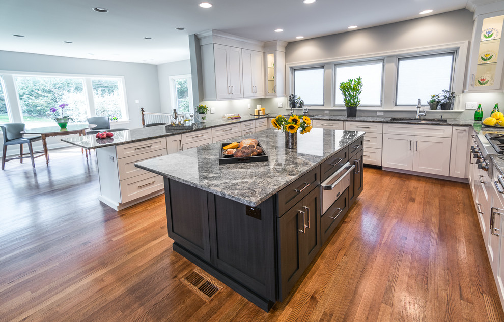 Inspiration for a mid-sized transitional medium tone wood floor eat-in kitchen remodel in St Louis with a single-bowl sink, shaker cabinets, white cabinets, granite countertops, stainless steel appliances and two islands