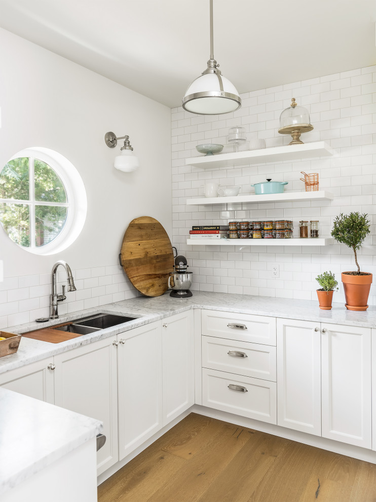 Kitchen pantry - mid-sized transitional u-shaped light wood floor and beige floor kitchen pantry idea with an undermount sink, shaker cabinets, white cabinets, quartz countertops, white backsplash, subway tile backsplash, stainless steel appliances, no island and white countertops