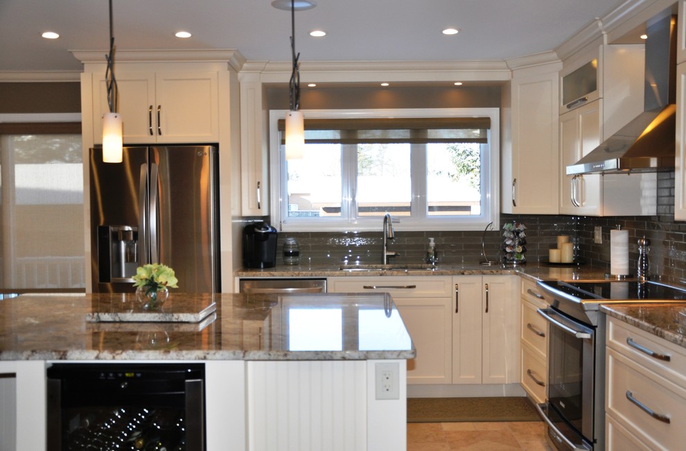 Open concept kitchen - large transitional l-shaped ceramic tile open concept kitchen idea in Toronto with an undermount sink, shaker cabinets, beige cabinets, granite countertops, glass tile backsplash, stainless steel appliances and an island