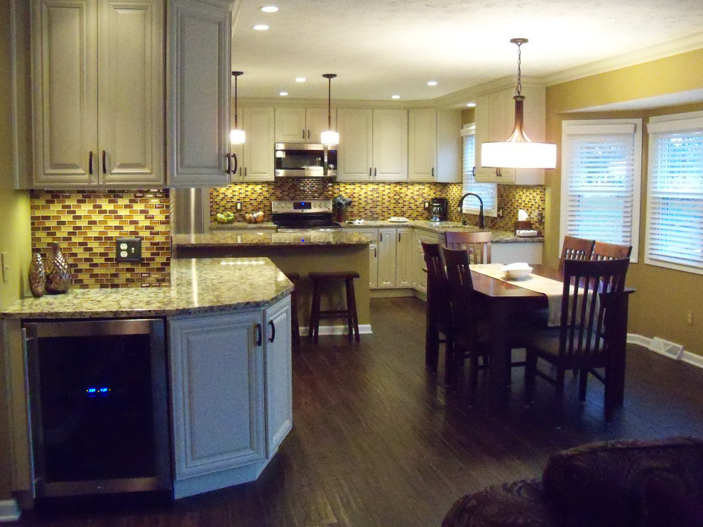 Inspiration for a transitional ceramic tile and brown floor open concept kitchen remodel in Cleveland with a single-bowl sink, raised-panel cabinets, white cabinets, granite countertops, brown backsplash, glass tile backsplash, stainless steel appliances, an island and beige countertops