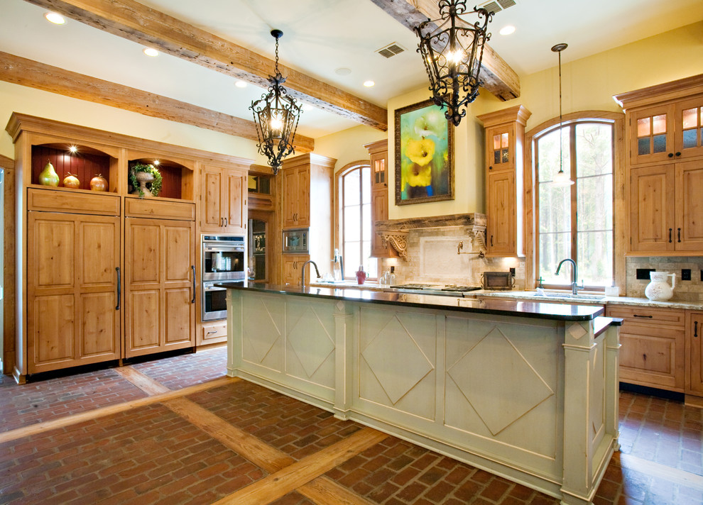 This is an example of a traditional l-shaped kitchen in Dallas with brick floors.