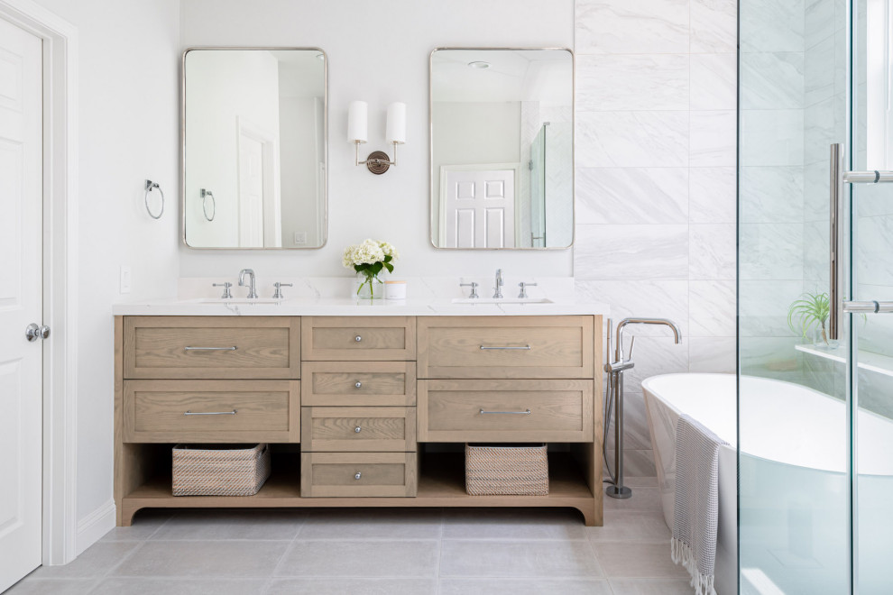 Large traditional ensuite bathroom in Orange County with shaker cabinets, beige cabinets, a freestanding bath, a corner shower, a one-piece toilet, white tiles, cement tiles, white walls, cement flooring, a submerged sink, engineered stone worktops, grey floors, a hinged door, white worktops, double sinks and a freestanding vanity unit.