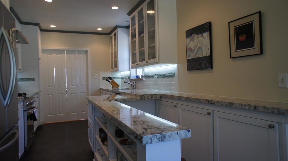 Arts and crafts galley eat-in kitchen in San Francisco with an undermount sink, shaker cabinets, white cabinets, quartz benchtops, white splashback, subway tile splashback and stainless steel appliances.