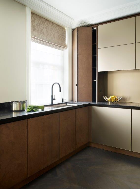 Design ideas for a mid-sized contemporary l-shaped separate kitchen in Buckinghamshire with an integrated sink, flat-panel cabinets, granite benchtops, metallic splashback, glass sheet splashback and black appliances.