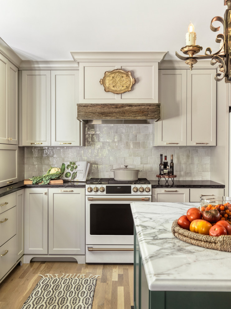 Large transitional u-shaped light wood floor and brown floor kitchen pantry photo in St Louis with an undermount sink, shaker cabinets, green cabinets, marble countertops, white backsplash, terra-cotta backsplash, white appliances, an island and white countertops