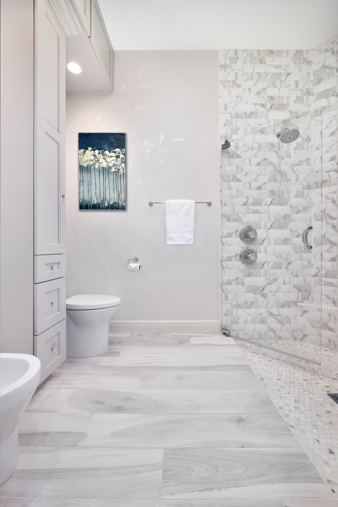 Example of a mid-sized trendy master white tile and marble tile ceramic tile, white floor, double-sink and wallpaper walk-in shower design in Miami with recessed-panel cabinets, white cabinets, a bidet, white walls, an undermount sink, quartz countertops, a hinged shower door, white countertops and a built-in vanity