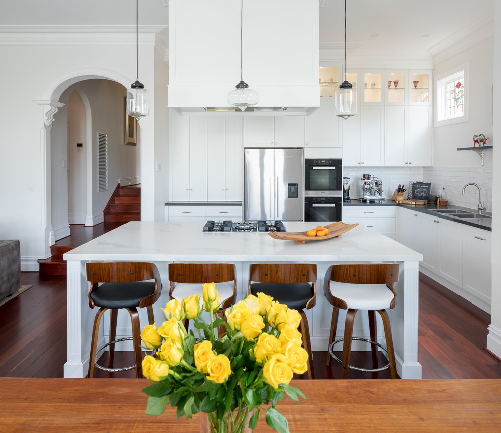 This is an example of a traditional kitchen in Perth with a double-bowl sink, shaker cabinets, white cabinets, quartz benchtops, white splashback, subway tile splashback, stainless steel appliances, with island and multi-coloured benchtop.