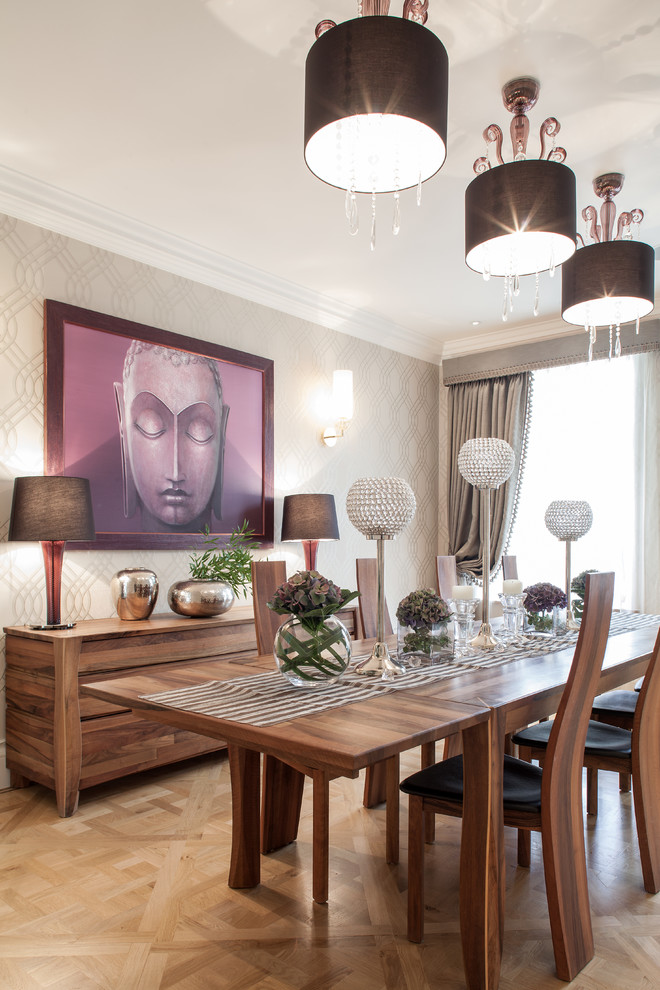 Photo of a transitional dining room in London with beige walls, medium hardwood floors and no fireplace.