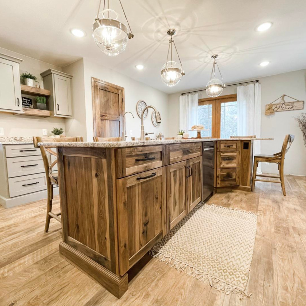 Photo of a mid-sized country l-shaped eat-in kitchen in Other with beaded inset cabinets, distressed cabinets, granite benchtops, white splashback, ceramic splashback, stainless steel appliances, with island and multi-coloured benchtop.