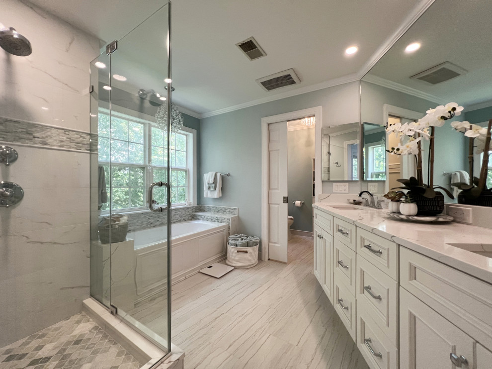 Photo of a large beach style master bathroom in New York with flat-panel cabinets, white cabinets, an alcove tub, a corner shower, a two-piece toilet, white tile, green walls, ceramic floors, an undermount sink, engineered quartz benchtops, grey floor, a hinged shower door, white benchtops, a niche, a double vanity and a built-in vanity.