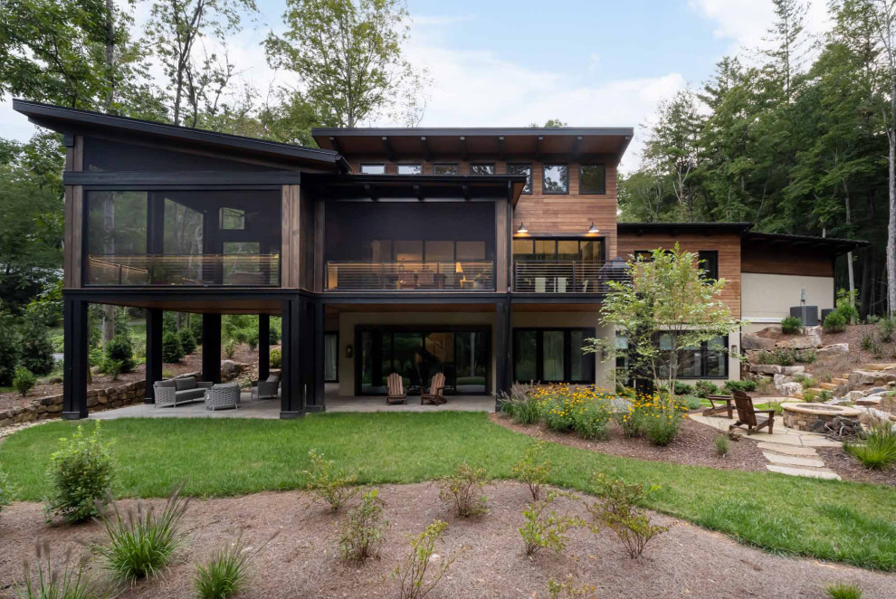 Example of a mid-sized transitional two-story mixed siding exterior home design with a metal roof