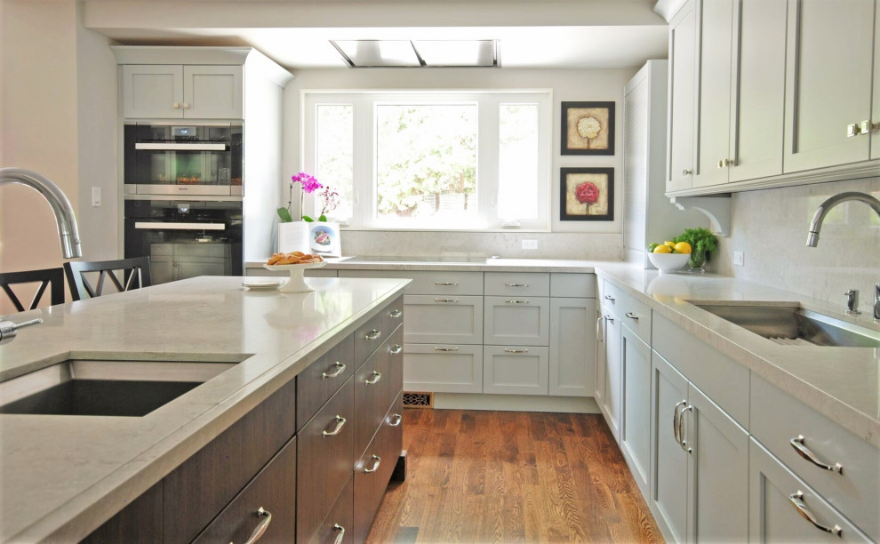 Mid-sized transitional l-shaped medium tone wood floor open concept kitchen photo with an undermount sink, recessed-panel cabinets, blue cabinets, quartz countertops, white backsplash, quartz backsplash, an island and white countertops