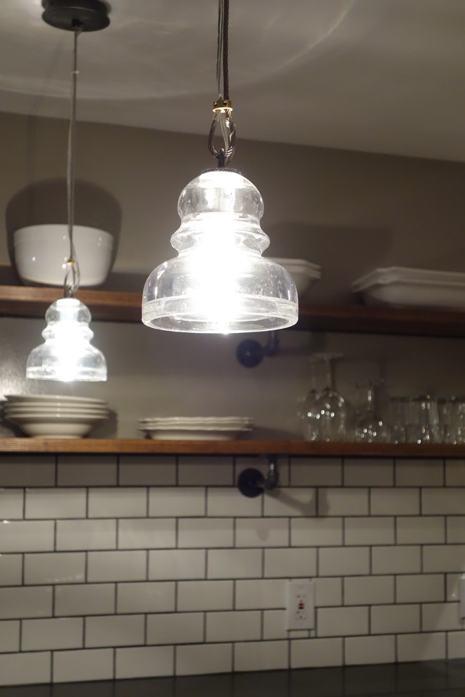 Inspiration for a small industrial galley medium tone wood floor eat-in kitchen remodel in Seattle with an undermount sink, recessed-panel cabinets, white cabinets, quartz countertops, white backsplash, ceramic backsplash, stainless steel appliances and a peninsula