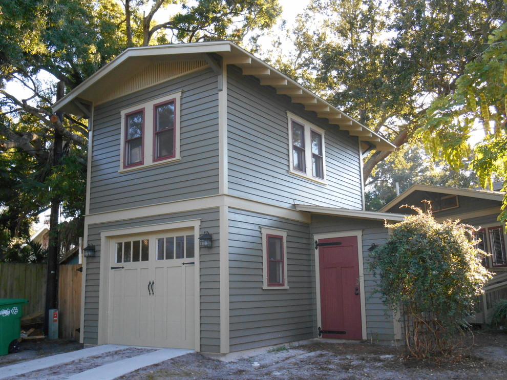 Small arts and crafts two-storey grey house exterior in Tampa with wood siding and a gable roof.