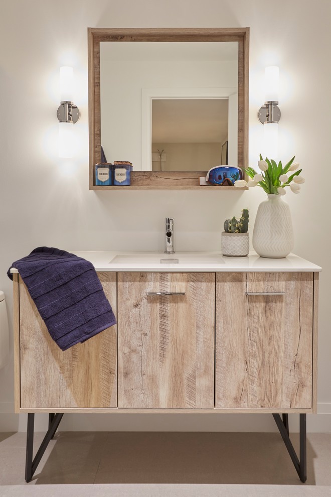 Large country bathroom in Toronto with furniture-like cabinets, distressed cabinets, an alcove shower, a one-piece toilet, white walls, light hardwood floors, a drop-in sink, solid surface benchtops, beige floor, a hinged shower door and white benchtops.