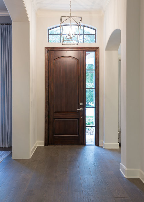 Design ideas for a small transitional foyer in Orlando with white walls, medium hardwood floors, a single front door, a medium wood front door and brown floor.