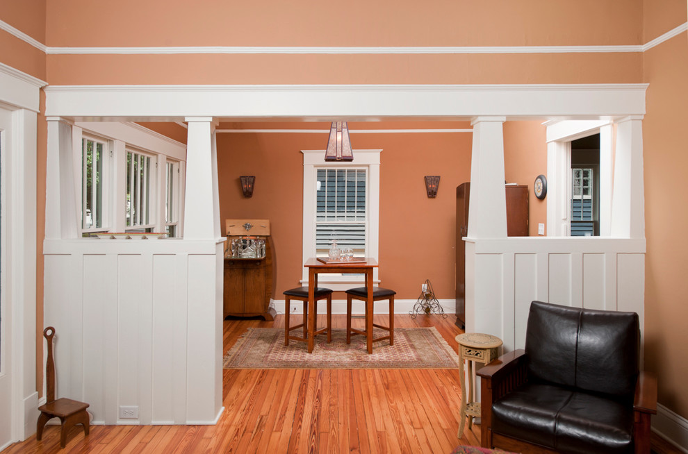 Photo of a traditional dining room in Atlanta with beige walls and medium hardwood floors.