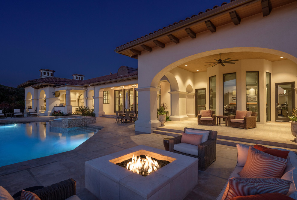 Inspiration for an expansive transitional backyard patio in Austin with a fire feature and a roof extension.