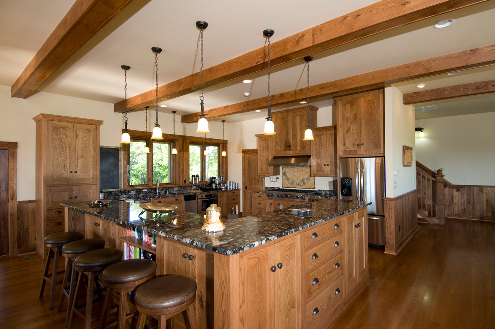 Design ideas for a large country u-shaped open plan kitchen in Other with shaker cabinets, granite benchtops, stainless steel appliances, medium hardwood floors, an undermount sink and medium wood cabinets.