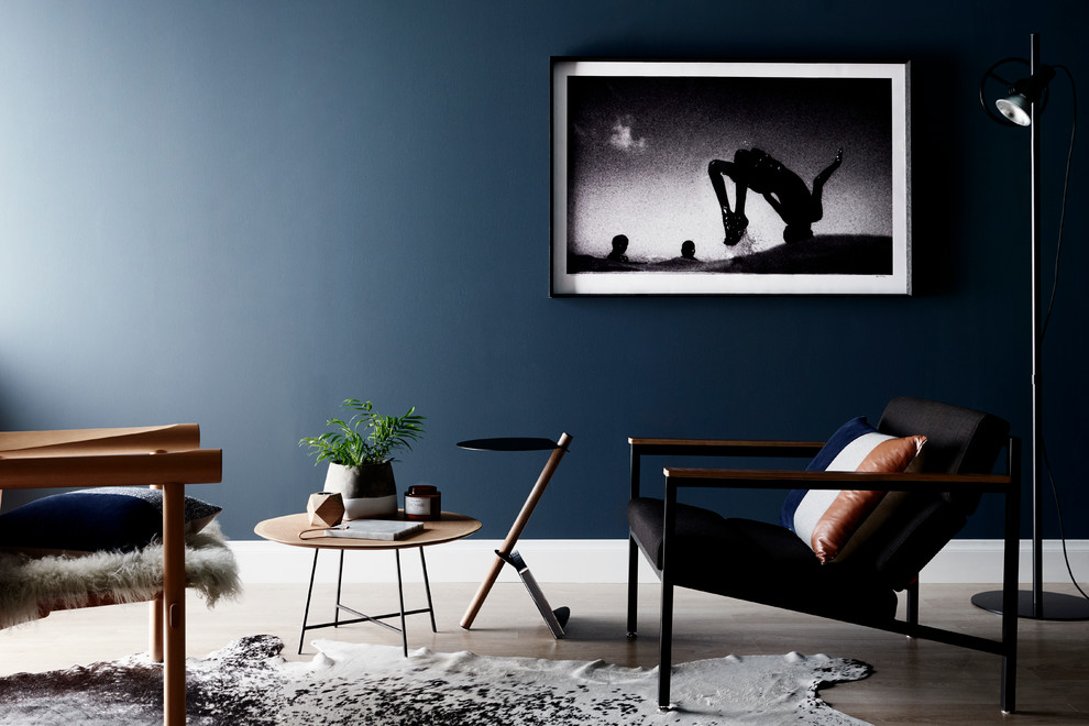 This is an example of a contemporary living room in Melbourne with black walls.