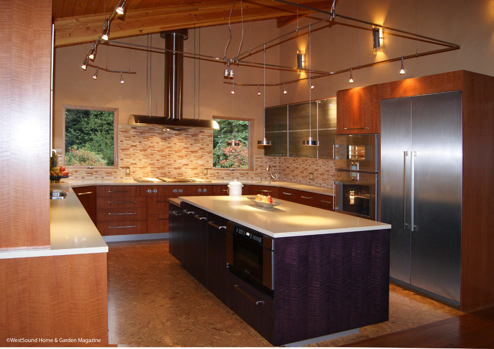 This is an example of a large contemporary u-shaped open plan kitchen in Seattle with an undermount sink, flat-panel cabinets, medium wood cabinets, quartz benchtops, multi-coloured splashback, stainless steel appliances, cork floors, with island, ceramic splashback, brown floor, beige benchtop and vaulted.