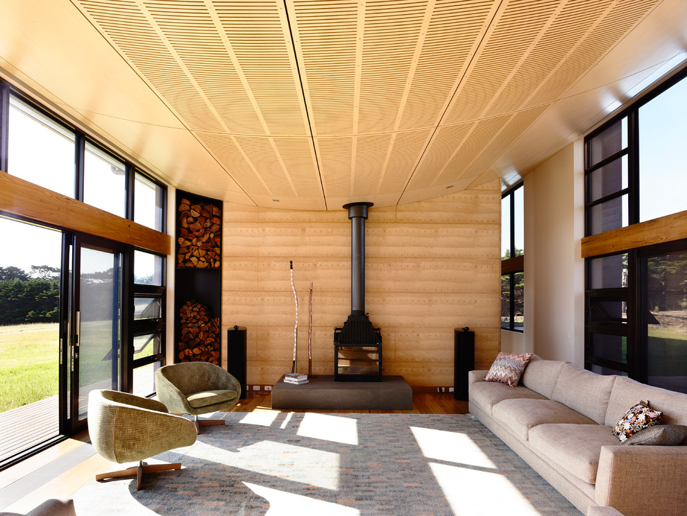 Photo of a large contemporary open concept living room in Melbourne with a hanging fireplace.