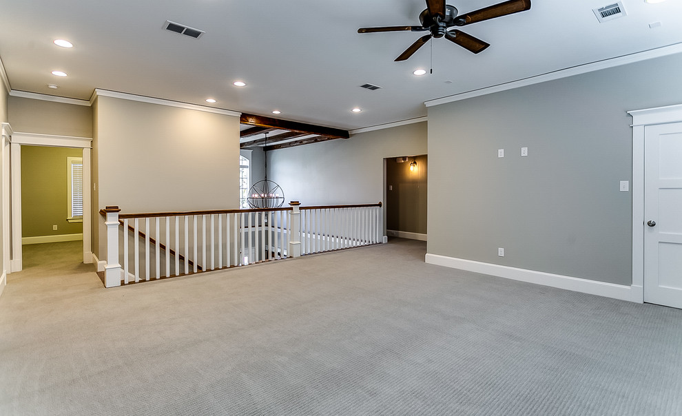 This is an example of a large traditional formal loft-style living room in Dallas with grey walls, carpet and a freestanding tv.