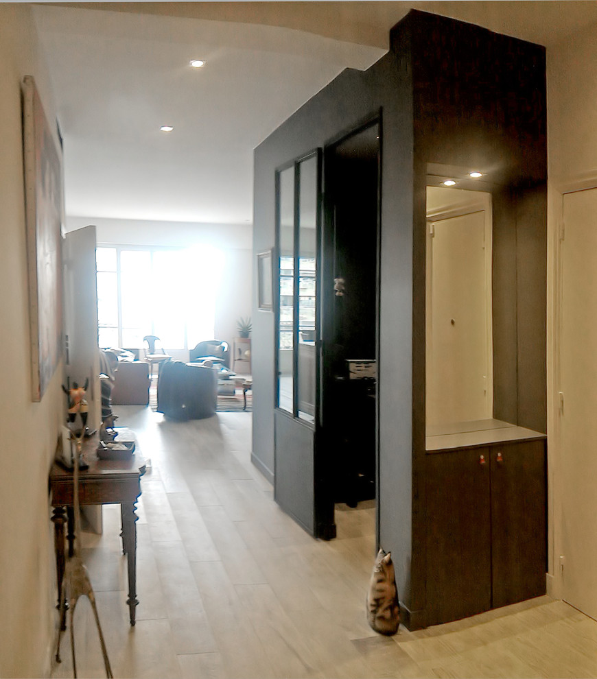 This is an example of a mid-sized industrial foyer in Other with grey walls, ceramic floors and beige floor.