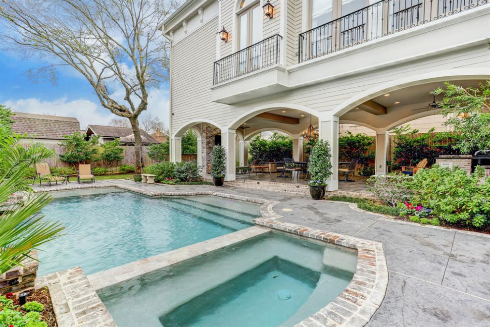 Example of a huge transitional backyard brick and rectangular hot tub design in Houston